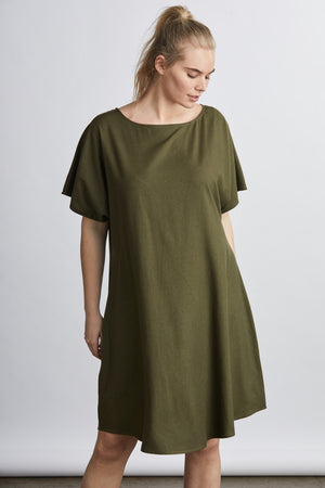 woman wearing a green raw silk noil belted knee length dress 