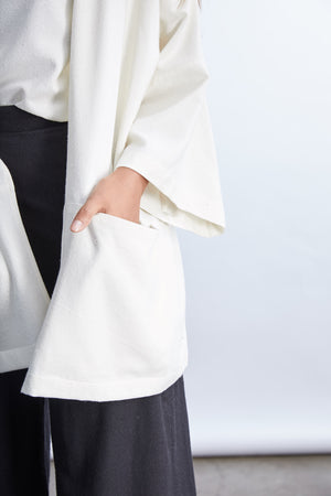 woman wearing a size medium tan raw silk noil oversized cardigan