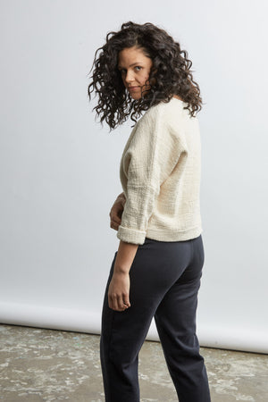 woman wearing a size medium handwoven cream sweater with black pants