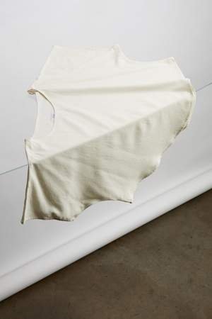 model wearing a white flowy raw silk noil blouse and black pants