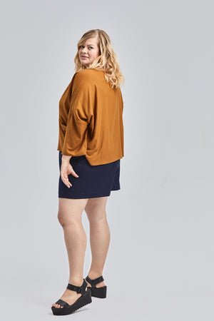 woman wearing green raw silk noil high waisted shorts and white tee shirt