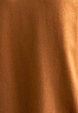 woman wearing green raw silk noil high waisted shorts and white tee shirt